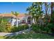 Single-story home with a terracotta tile roof and lush landscaping at 441 Village Dr, Tarpon Springs, FL 34689