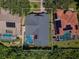 Aerial view of the house showing the backyard pool and proximity to other homes at 957 Westwinds Blvd, Tarpon Springs, FL 34689