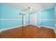Bedroom featuring wood floors, ceiling fan, and a closet at 957 Westwinds Blvd, Tarpon Springs, FL 34689