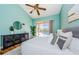 Light and airy bedroom with a king-size bed and wood floors at 957 Westwinds Blvd, Tarpon Springs, FL 34689