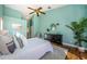 Spacious bedroom with light teal walls, wood floors, and ceiling fan at 957 Westwinds Blvd, Tarpon Springs, FL 34689