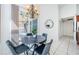 Bright dining area with a round table and four chairs, near sliding doors leading to a patio at 957 Westwinds Blvd, Tarpon Springs, FL 34689