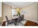 Bright dining room featuring hardwood floors and a modern table at 957 Westwinds Blvd, Tarpon Springs, FL 34689