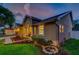 Well-maintained home with tidy landscaping, soft exterior lighting, and a spacious front yard at 957 Westwinds Blvd, Tarpon Springs, FL 34689