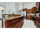 Spacious kitchen with granite countertops and dark wood cabinets at 957 Westwinds Blvd, Tarpon Springs, FL 34689