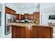 Modern kitchen with granite countertops and wood cabinets at 957 Westwinds Blvd, Tarpon Springs, FL 34689