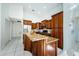 Kitchen with breakfast bar, granite counters, and stainless steel appliances at 957 Westwinds Blvd, Tarpon Springs, FL 34689