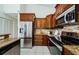 Modern kitchen featuring stainless steel appliances and tile flooring at 957 Westwinds Blvd, Tarpon Springs, FL 34689