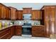 Updated kitchen with wood cabinets and granite countertops at 957 Westwinds Blvd, Tarpon Springs, FL 34689