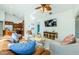 Bright living room features comfortable seating and a large flat-screen TV at 957 Westwinds Blvd, Tarpon Springs, FL 34689