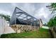 Screened outdoor space with stone accents and a shady lounge at 957 Westwinds Blvd, Tarpon Springs, FL 34689