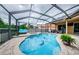 Inviting kidney-shaped pool with a screened enclosure at 957 Westwinds Blvd, Tarpon Springs, FL 34689