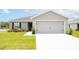 Newly built home with a two-car garage and well-manicured lawn at 102 Eagle Summit Dr, Ruskin, FL 33570