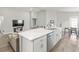 Modern kitchen with white cabinets, stainless steel appliances, and marble countertops at 102 Eagle Summit Dr, Ruskin, FL 33570