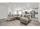 Spacious living room with a large sectional sofa and wood-look floors at 102 Eagle Summit Dr, Ruskin, FL 33570