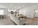 Spacious living room with a large sectional sofa and wood-look floors at 102 Eagle Summit Dr, Ruskin, FL 33570