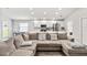 Spacious living room with a large sectional sofa and wood-look floors at 102 Eagle Summit Dr, Ruskin, FL 33570