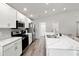 Modern kitchen with white cabinets, stainless steel appliances, and marble countertops at 102 Eagle Summit Dr, Ruskin, FL 33570