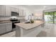 Modern kitchen with gray cabinets, granite countertops, and island at 2926 Suncoast Plains Dr, Odessa, FL 33556