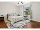 Bright bedroom with wood floors, ceiling fan, and cat tree at 2926 Suncoast Plains Dr, Odessa, FL 33556
