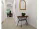 Bright hallway with tile flooring, half-wall, and a wooden console table at 2926 Suncoast Plains Dr, Odessa, FL 33556