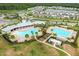 Aerial view of community pool, houses, and lake at 2926 Suncoast Plains Dr, Odessa, FL 33556