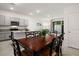 Dining area with dark wooden table and chairs, adjacent to kitchen at 2926 Suncoast Plains Dr, Odessa, FL 33556