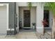 Inviting front entrance with a black door and potted plants at 2926 Suncoast Plains Dr, Odessa, FL 33556