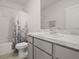 Clean bathroom with a shower/tub combo and gray vanity at 2926 Suncoast Plains Dr, Odessa, FL 33556