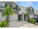 Townhouse exterior with gray siding and a two-car garage at 2926 Suncoast Plains Dr, Odessa, FL 33556