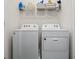 Laundry room with washer and dryer, and overhead shelving at 2926 Suncoast Plains Dr, Odessa, FL 33556