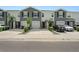Three-unit townhome building with gray exterior and attached garages at 2926 Suncoast Plains Dr, Odessa, FL 33556