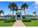 Community clubhouse with palm trees and brick pathway at 2926 Suncoast Plains Dr, Odessa, FL 33556