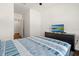 Bright bedroom with a double bed, dresser, and TV at 2926 Suncoast Plains Dr, Odessa, FL 33556