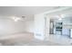 Open living room with view into kitchen and neutral carpeting at 3543 Seffner Dr, Holiday, FL 34691