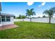 Spacious backyard with grassy area and privacy fence at 3543 Seffner Dr, Holiday, FL 34691