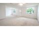 Spacious living room featuring neutral carpeting and ample natural light at 3543 Seffner Dr, Holiday, FL 34691