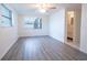 Grey wood-look floor bedroom with access to a bathroom and window at 3543 Seffner Dr, Holiday, FL 34691