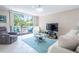 Relaxing living room with comfortable sofas and a large TV, and access to balcony at 2612 Pearce Dr # 306, Clearwater, FL 33764