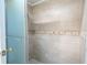 Clean shower with tile surround and built-in shelf at 2612 Pearce Dr # 306, Clearwater, FL 33764