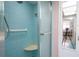 Clean and spacious shower with blue tile and bench at 2612 Pearce Dr # 306, Clearwater, FL 33764