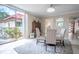 Charming dining area with glass table and patterned chairs, near balcony access at 2612 Pearce Dr # 306, Clearwater, FL 33764
