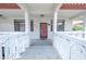 Condo building entry with red door and balcony at 2612 Pearce Dr # 306, Clearwater, FL 33764