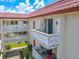 Building exterior view showing multiple balconies and landscaping at 2612 Pearce Dr # 306, Clearwater, FL 33764