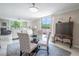 Bright dining area with glass table and patterned chairs, overlooking living room at 2612 Pearce Dr # 306, Clearwater, FL 33764