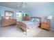 Bedroom with light blue walls, double dresser, and a queen-size bed at 2612 Pearce Dr # 306, Clearwater, FL 33764