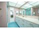 Bathroom with a double vanity and a large mirror at 2612 Pearce Dr # 306, Clearwater, FL 33764
