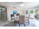 Elegant dining area with glass table and patterned chairs, open to living room at 2612 Pearce Dr # 306, Clearwater, FL 33764