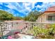Relaxing balcony with patio furniture and lush greenery, offering a peaceful view at 2612 Pearce Dr # 306, Clearwater, FL 33764