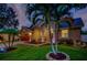 Attractive one-story house with well-maintained landscaping at night at 957 Westwinds Blvd, Tarpon Springs, FL 34689